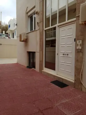 a building with a white garage door and a red floor at Lily of Crete 1 - Sea & Beach front Apartment in Kalamaki Chanion