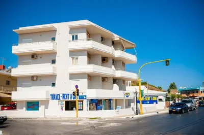 a white building on a street corner with a traffic light at Lily of Crete 1 - Sea & Beach front Apartment in Kalamaki Chanion