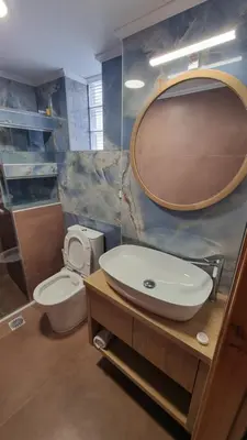 a bathroom with a sink and a toilet and a mirror at Villa Mimagia Apartments in Palaiochóra