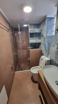 a bathroom with a shower and a toilet and a sink at Villa Mimagia Apartments in Palaiochóra