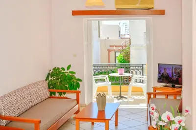 a living room with a couch and a table at Villa Mimagia Apartments in Palaiochóra