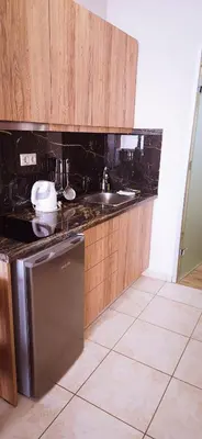 a kitchen with a sink and a dishwasher at Kalimera Hotel in Agia Marina Nea Kydonias