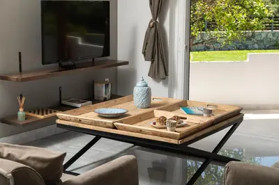 a coffee table in a living room with a tv at Villa Tranquilla in Kolymvari
