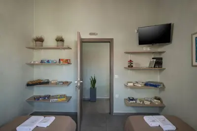 a room with a door and a television on a wall at Villa Roxanne in Galatás