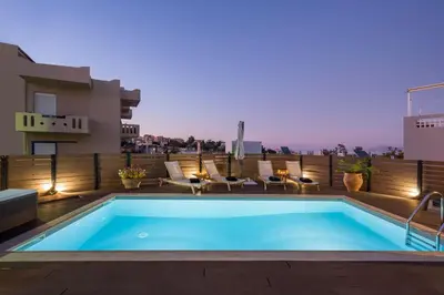 a swimming pool on the roof of a house at Villa Roxanne in Galatás