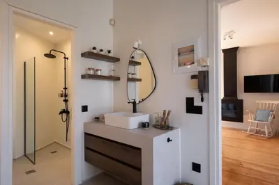 a bathroom with a sink and a mirror at MV Living - Retreat in Daratso