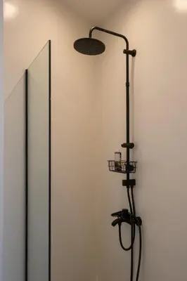 a shower in a room with a mirror at MV Living - Retreat in Daratso