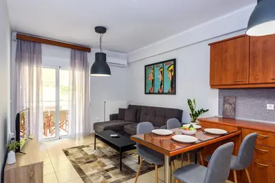a living room with a table and a couch at Apartment A80 in Chania Town