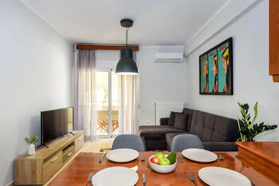 a living room with a table and a couch at Apartment A80 in Chania Town