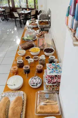a long table filled with food and plates and bread at Frida Apartments in Chania Town