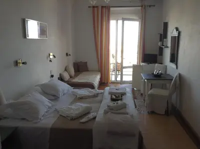 a bedroom with a large bed with towels on it at Akrotiri Hotel in Chania Town