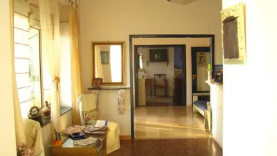 a living room with a door open to a living room at Akrotiri Hotel in Chania Town