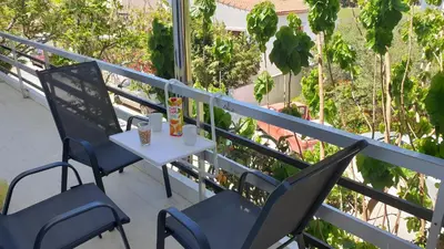 a table and two chairs on a balcony at Enjoy Sunset in Palaiochóra