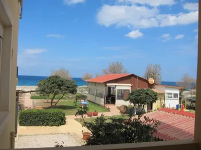 a small house with a view of the ocean at Baladinos Apartments in Gerani Chanion