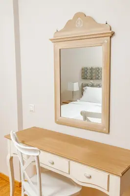 a bedroom with a dresser and a mirror at Charming and Comfy House in Agia Marina Nea Kydonias