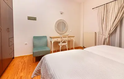 a bedroom with a bed and a desk and a chair at Charming and Comfy House in Agia Marina Nea Kydonias