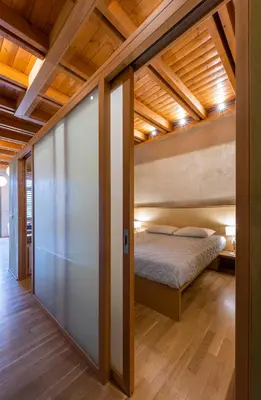 a bedroom with a bed in a room with wooden ceilings at Polixeny's Suites in Chania Town