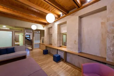 a living room with a couch and a large window at Polixeny's Suites in Chania Town