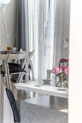 a white table with flowers on it in a room at Nikis Apartment in Chania Town