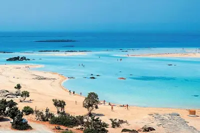 a group of people on a beach in the ocean at Nikis Apartment in Chania Town