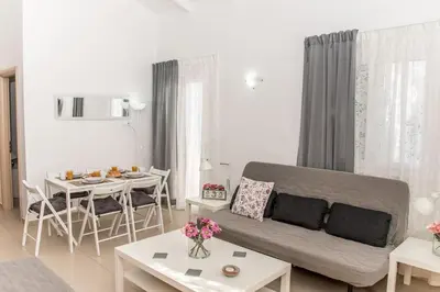 a living room with a couch and a table at Nikis Apartment in Chania Town