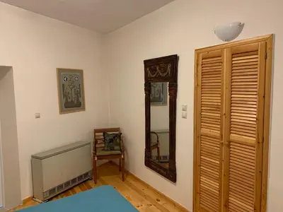 a bedroom with a mirror on the wall and a door at Tastefully Decorated One-bedroom Apartment - Chania in Chania Town