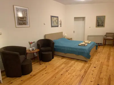 a bedroom with a bed and two chairs and a table at Tastefully Decorated One-bedroom Apartment - Chania in Chania Town
