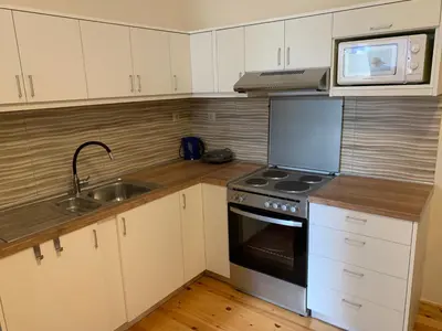 a kitchen with a stove and a microwave and a sink at Tastefully Decorated One-bedroom Apartment - Chania in Chania Town