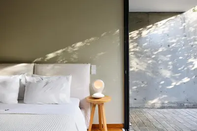 a bedroom with a white bed and a window at Villa 7 in Perivólia