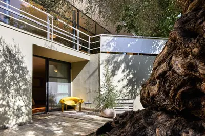 a modern house with a yellow chair on a patio at Villa 7 in Perivólia