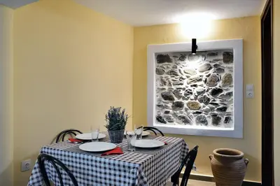 a dining room table with a checkered table cloth at George & Helen's House in Ayiá