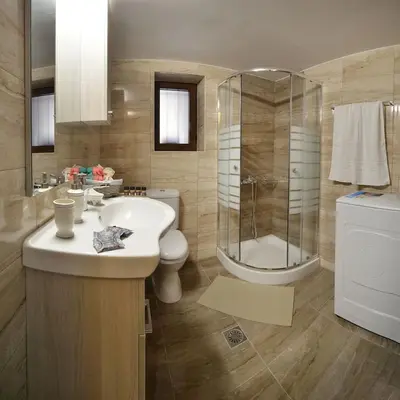 a bathroom with a sink and a shower and a toilet at George & Helen's House in Ayiá