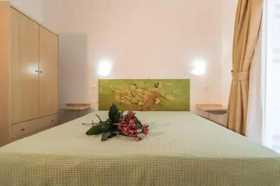 a bedroom with a bed with a flower arrangement on it at Manto Studios in Palaiochóra