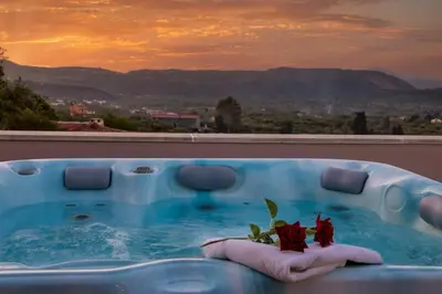 a bath tub with two red roses in it at Olga's Filoxenia - Villa Aladanos-private pool and heated jacuzzi in Makhairoí