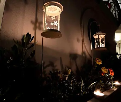 two lights are hanging in a room with plants at Sea Breeze in Kalamaki Chanion