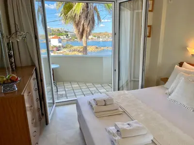 a bedroom with a bed with a view of the ocean at Sea Breeze in Kalamaki Chanion