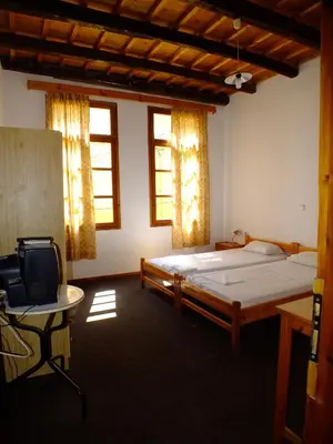 a bedroom with a bed and a desk and a tv at Lito Rooms in Chania Town