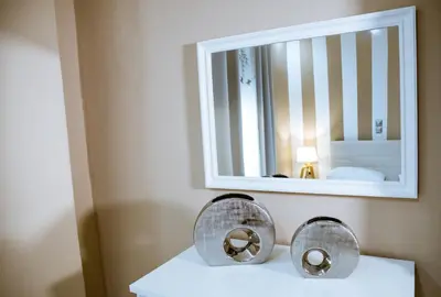 a bathroom with a mirror and a sink at Raimonda's House in Chania Town