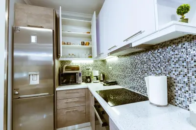 a kitchen with a stainless steel refrigerator and tiles at Raimonda's House in Chania Town