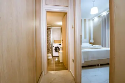 a hallway leading to a bedroom with a bed at Raimonda's House in Chania Town