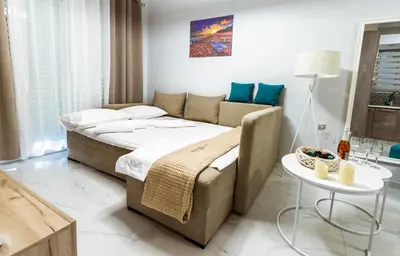a bedroom with a large bed and a couch at Raimonda's House in Chania Town