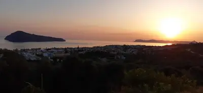 a view of a city with the sunset in the background at Thea Apartment in Agia Marina Nea Kydonias