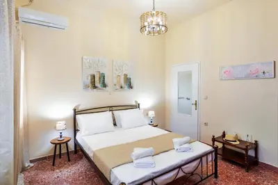 a bedroom with a bed and a chandelier at Michalis Stonehouse in Chania Town