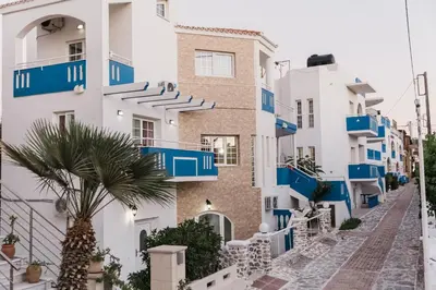 a street in positano with blue and white buildings at Bay View Apartments in Plataniás