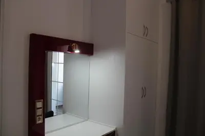 a bathroom with a mirror and a white cabinet at Bay View Apartments in Plataniás