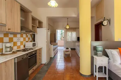 a kitchen with a sink and a stove at Evelia Apartment in Galatás