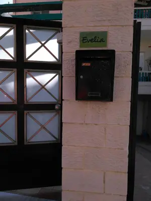 a brick wall with a door and a television on it at Evelia Apartment in Galatás