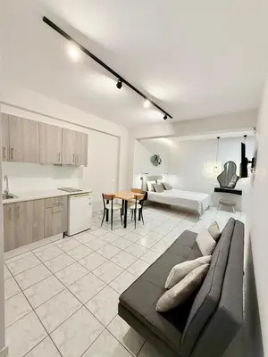 a kitchen and living room with a couch and a table at Avenue Hotel Falassarna in Falasarna