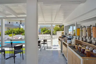 a kitchen with a table and chairs and a pool at Eloque Simple living space in Kato Daratso