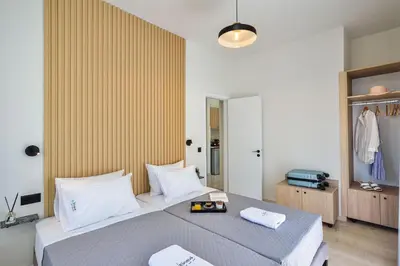 a bedroom with a bed with two towels on it at Eloque Simple living space in Kato Daratso